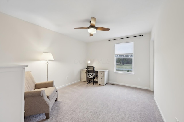 office space with light carpet, ceiling fan, visible vents, and baseboards