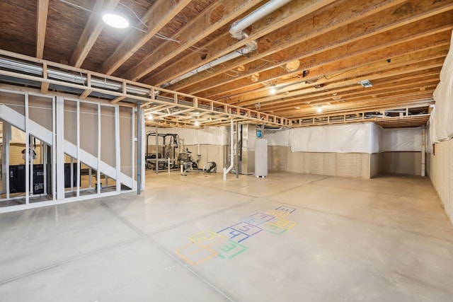 unfinished basement featuring water heater