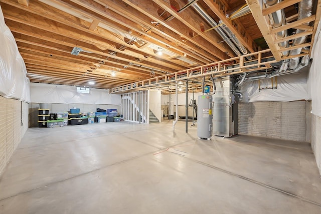 basement featuring water heater, brick wall, and heating unit