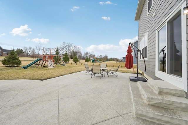 view of patio featuring a playground and outdoor dining space