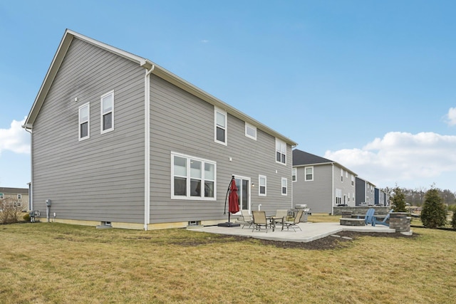 rear view of house featuring a patio and a yard