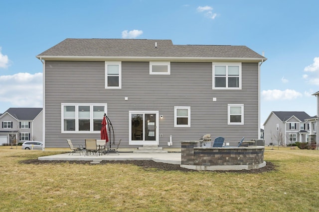 rear view of house with a yard, a shingled roof, entry steps, a patio area, and central AC