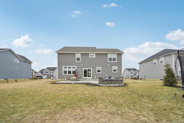 rear view of property featuring a yard and a patio area