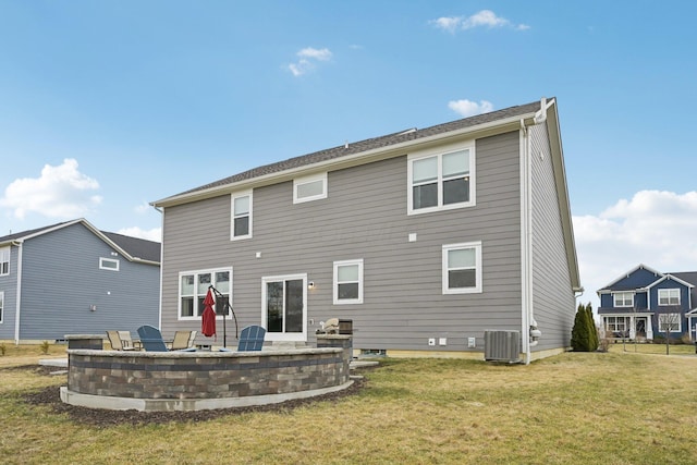 rear view of house featuring a patio area, a yard, and central air condition unit