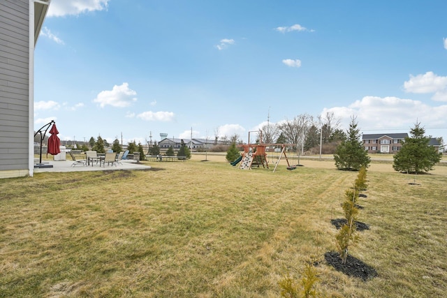 view of yard featuring playground community and a patio