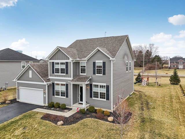 traditional home with a front lawn, aphalt driveway, board and batten siding, and roof with shingles