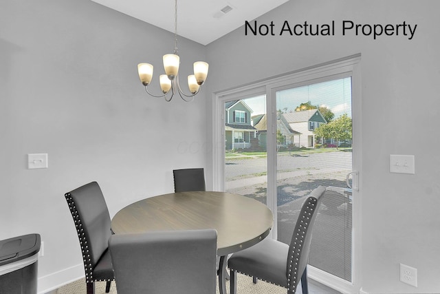 dining space featuring visible vents, a notable chandelier, and baseboards