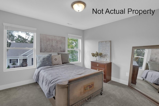 bedroom with carpet, visible vents, and baseboards