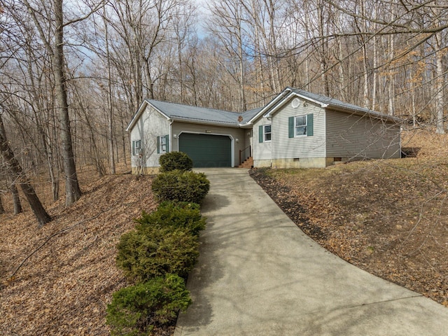 view of front of house featuring a garage, crawl space, metal roof, and concrete driveway