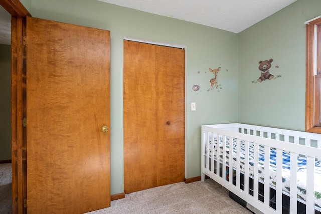 bedroom with a closet, carpet flooring, and baseboards