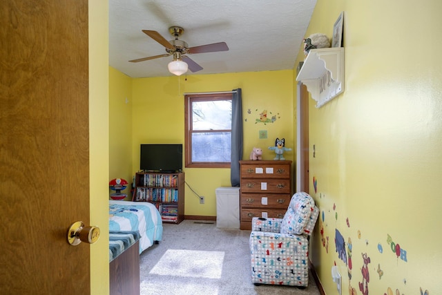 bedroom featuring a ceiling fan, carpet flooring, a textured ceiling, and baseboards