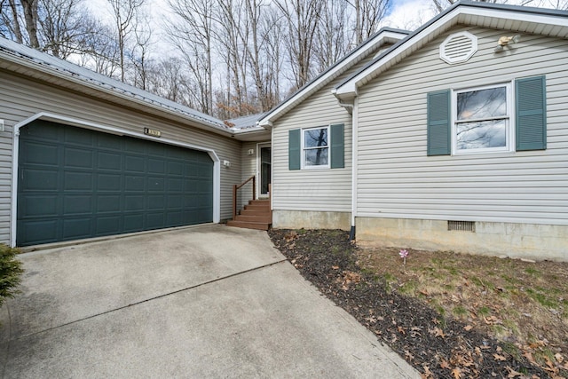 view of home's exterior featuring crawl space, driveway, a garage, and metal roof