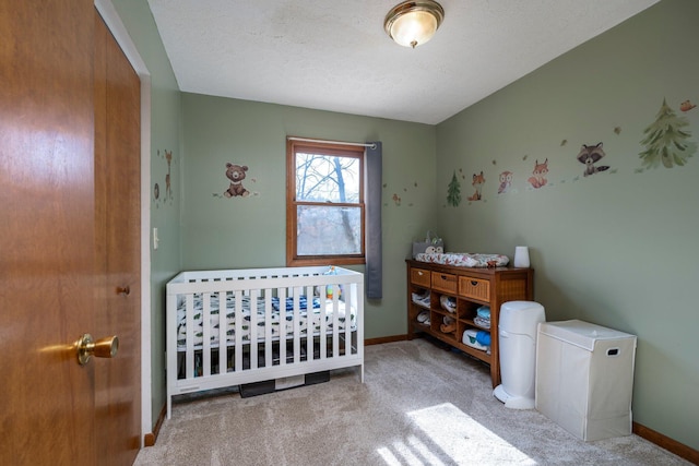 bedroom featuring carpet floors, baseboards, and a crib