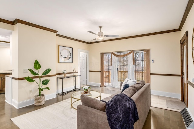 living room featuring baseboards, visible vents, ceiling fan, ornamental molding, and wood finished floors