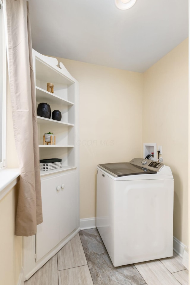 washroom with washer / dryer, laundry area, and baseboards