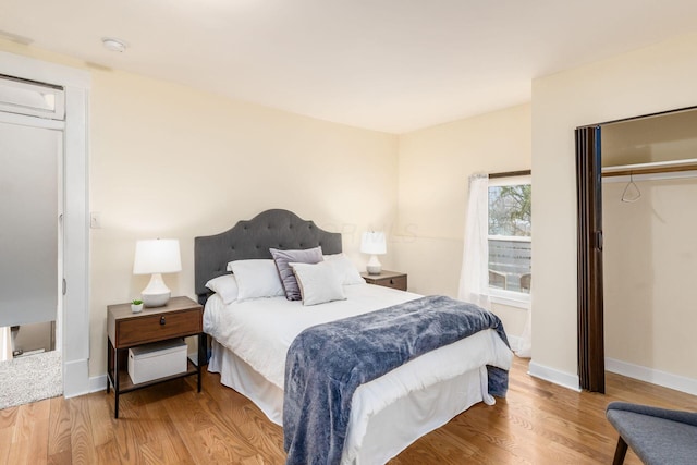 bedroom featuring wood finished floors and baseboards