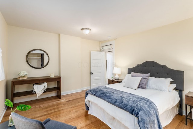 bedroom featuring baseboards and wood finished floors