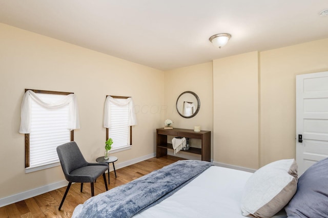 bedroom with baseboards and wood finished floors