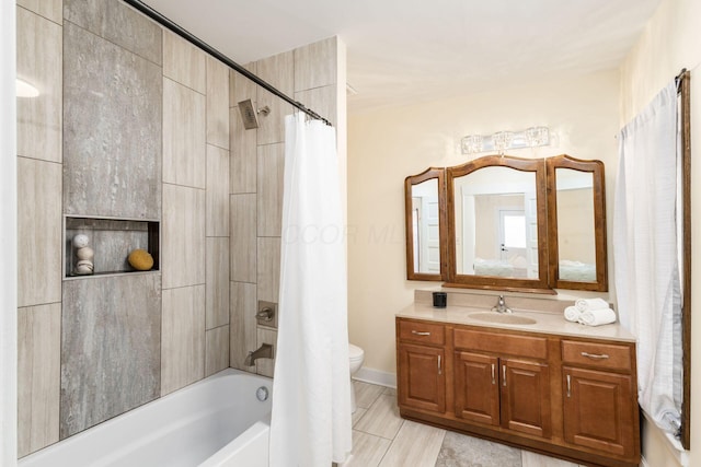 bathroom featuring toilet, shower / tub combo, and vanity