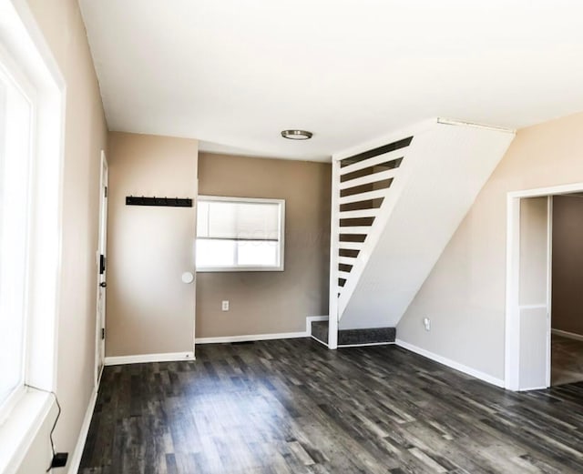 foyer featuring baseboards and wood finished floors