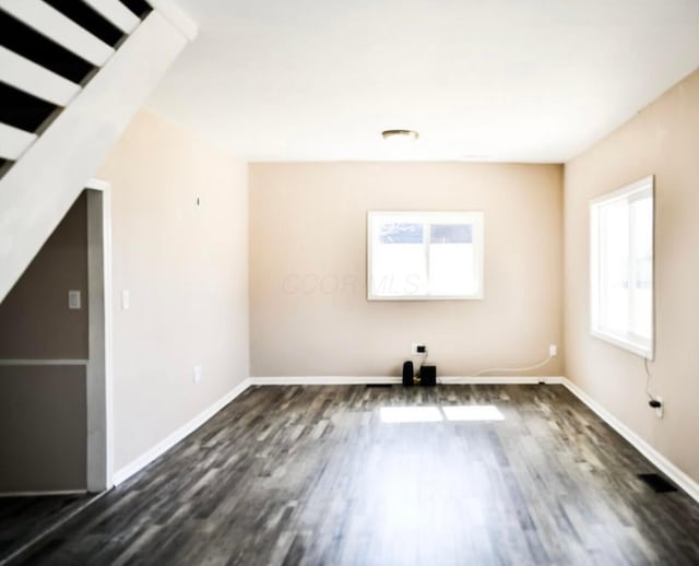 interior space with baseboards and dark wood-style floors