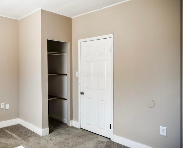 unfurnished bedroom with baseboards and carpet floors