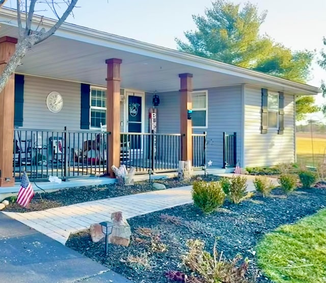 view of exterior entry with a porch