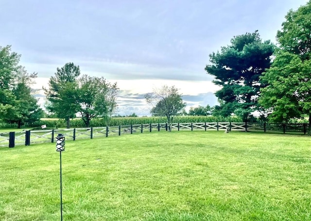 view of yard with a rural view and fence