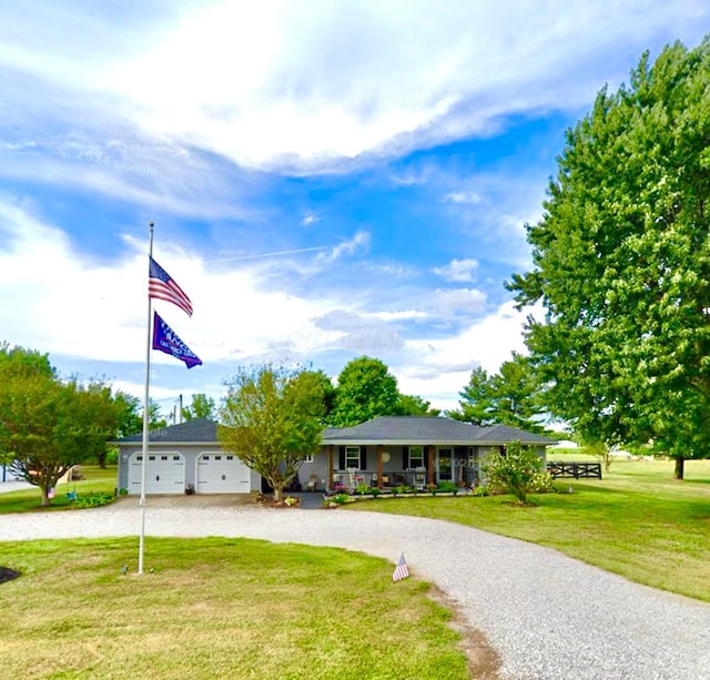 single story home featuring driveway, an attached garage, covered porch, and a front lawn