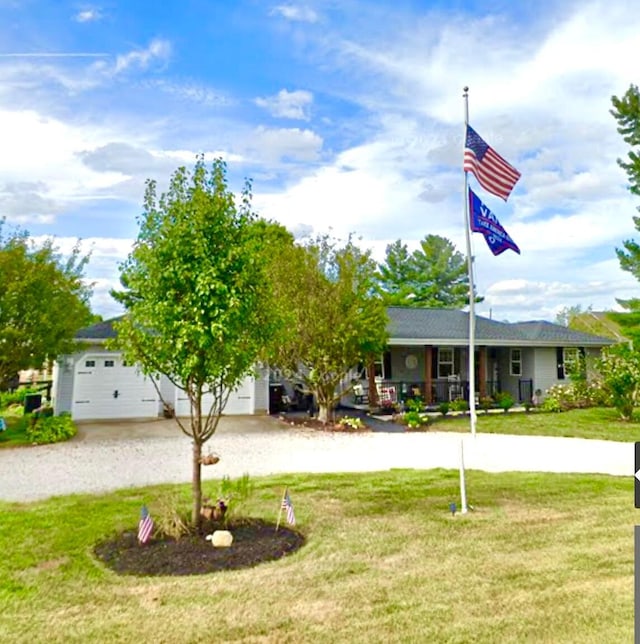 view of front of home with a front yard, a garage, and driveway