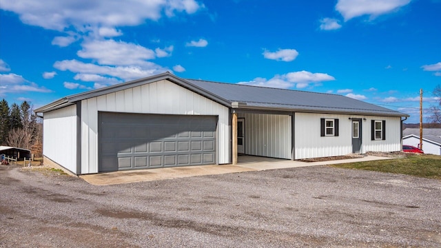 exterior space featuring a garage and metal roof