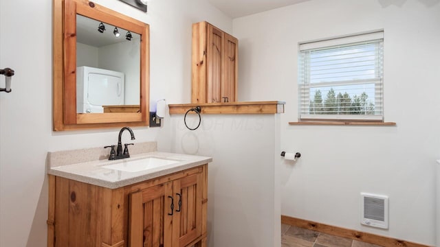 bathroom featuring visible vents, vanity, and baseboards