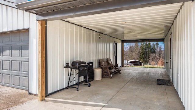 view of patio with a garage, an attached carport, and grilling area