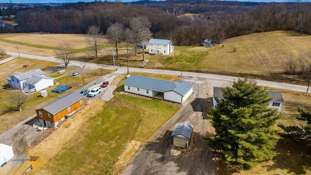 birds eye view of property with a view of trees
