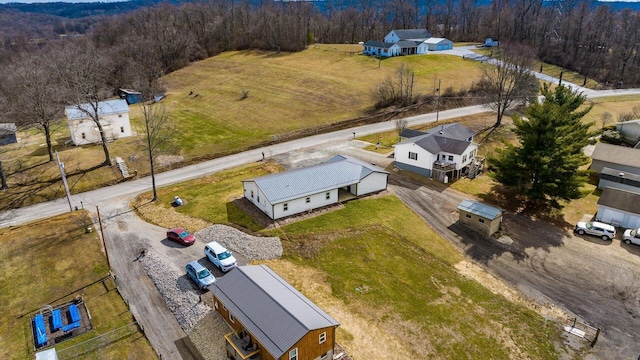 drone / aerial view with a wooded view