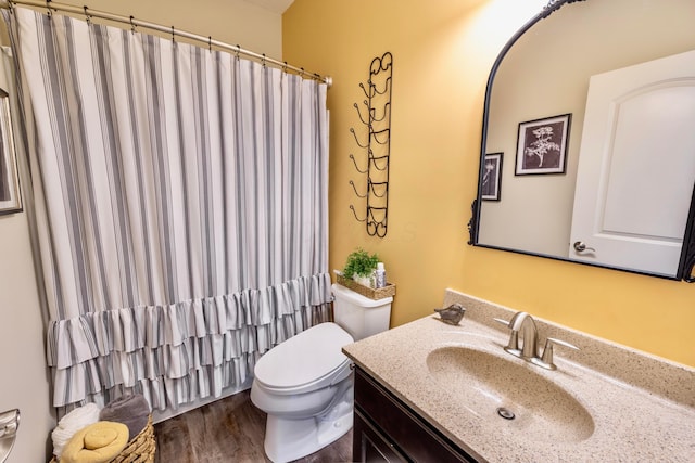 full bath with vanity, curtained shower, toilet, and wood finished floors