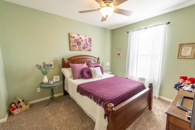 bedroom featuring baseboards, light colored carpet, and ceiling fan