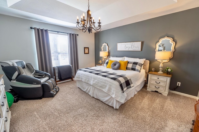 bedroom featuring a chandelier, baseboards, a tray ceiling, and carpet floors