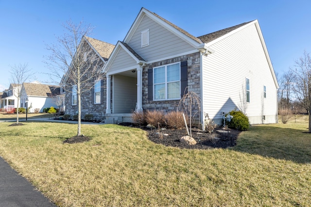 view of front of property with stone siding and a front lawn