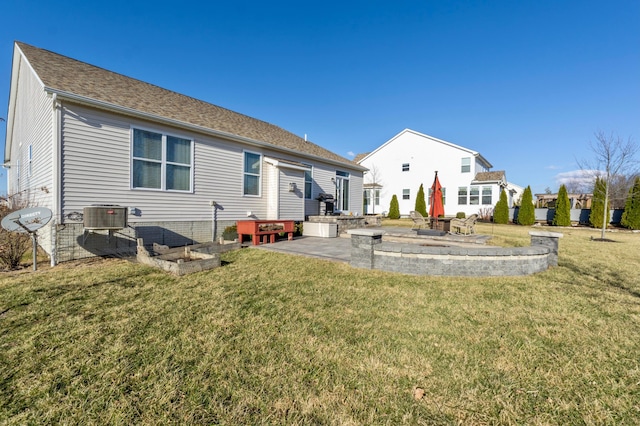 rear view of property featuring a patio area, a lawn, central AC, and a shingled roof