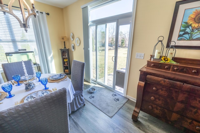 dining area with a healthy amount of sunlight, baseboards, and wood finished floors