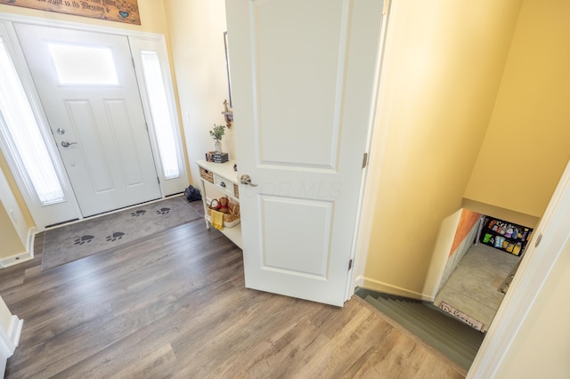 foyer entrance with light wood-style floors and baseboards