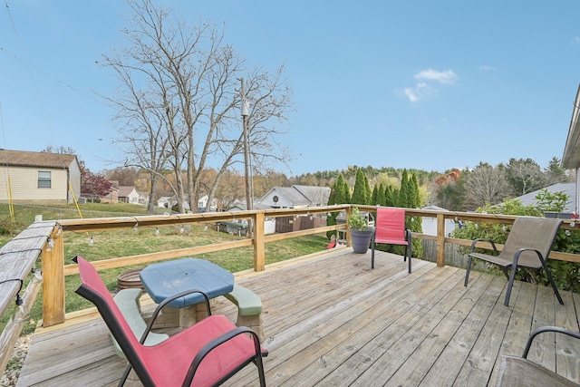 wooden terrace with a grill and a lawn