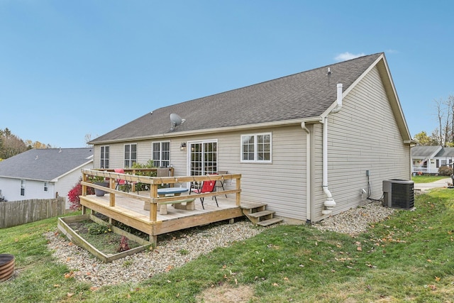 back of house with roof with shingles, a yard, fence, cooling unit, and a wooden deck