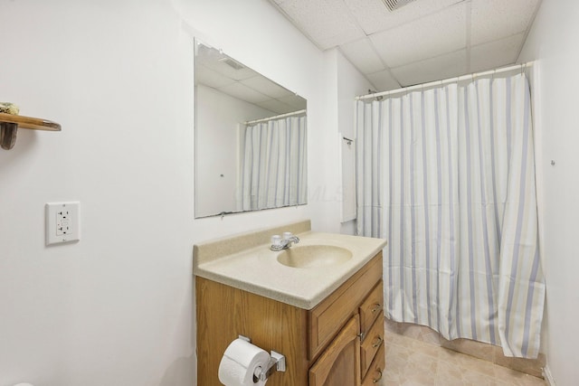 full bathroom featuring a shower with shower curtain, vanity, and a paneled ceiling