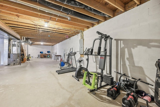 workout room featuring heating unit and electric panel