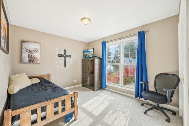 carpeted bedroom featuring visible vents and baseboards