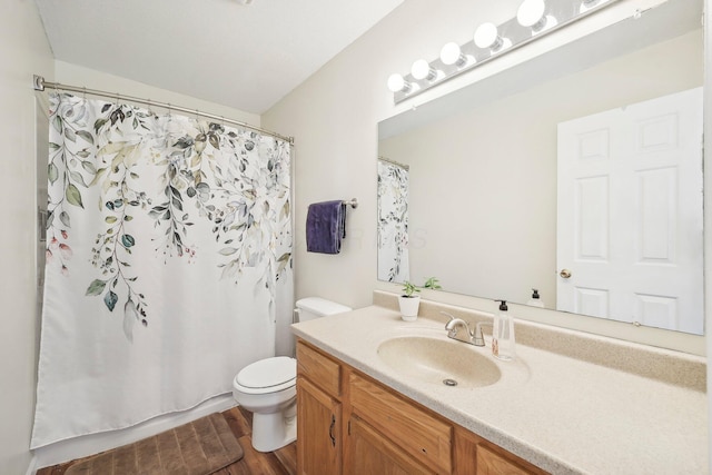 full bathroom featuring toilet, curtained shower, wood finished floors, and vanity