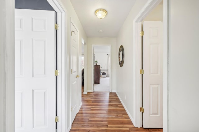 hall with wood finished floors and baseboards