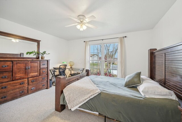 bedroom with a ceiling fan and light colored carpet